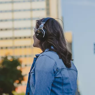 Woman wearing headphones looking into the distance